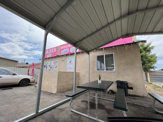 Food truck parking lot and seating area. Food truck shares parking lot with another business