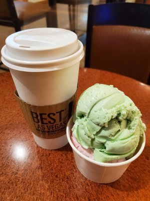 Pistachio and strawberry in a cup with a large coffee