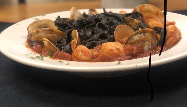 Homemade squid ink fettuccini Arrabiata
With Scallops, shrimp, and clams