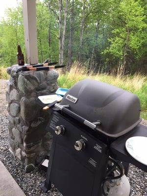 Grilling steaks while enjoying a beer