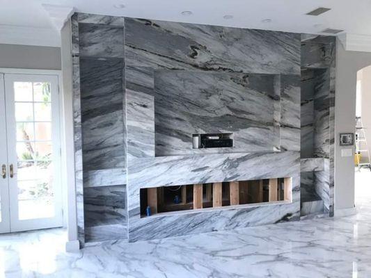 Entertainment and fireplace wall wrap in quartzite.