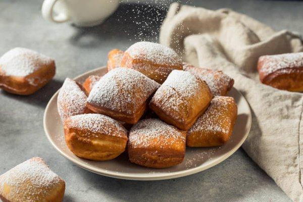 These beignets are soft and fluffy and are dusted with powdered sugar.