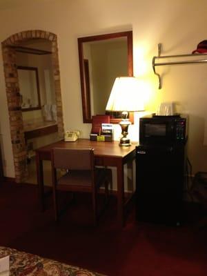 Desk, chair, fridge, microwave and a WiFi that can be a bit spotty but is included in a reasonable rate.