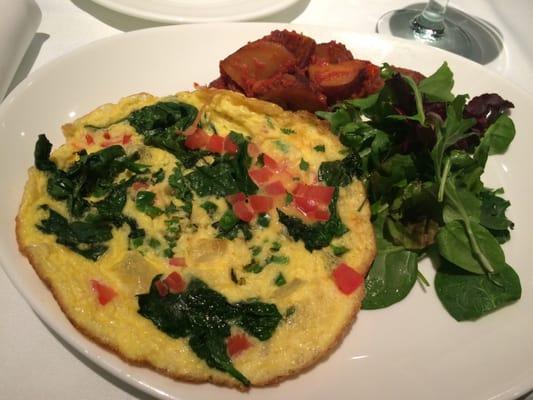 Spinach frittata, the potatoes are covered in tomato bits