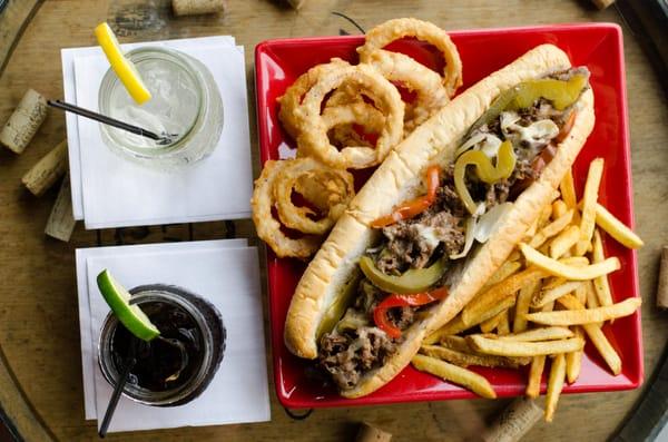 Philly Cheesteaks with crispy red nion rings and house cut fries.