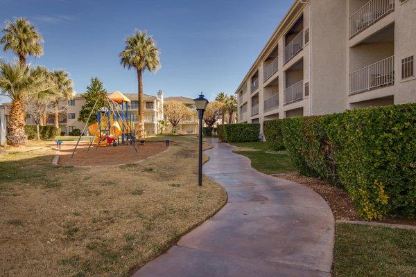 The walkway going behind building 14 between the playground and the building.