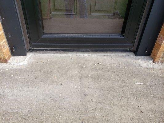 Flaking cement worker put in front threshold