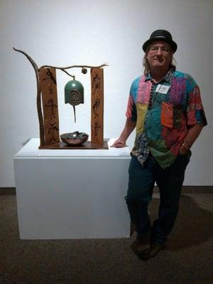 Tom Williams, co-owner and metal sculpture with his bell "Resonance".