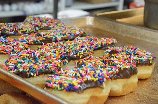 Chocolate iced donuts with sprinkles