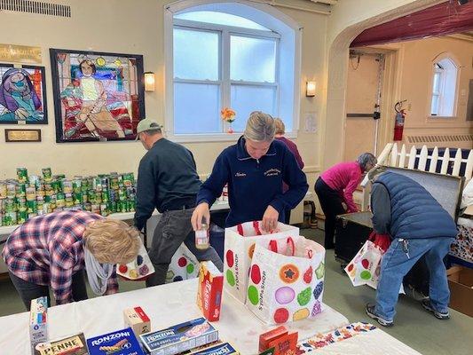 Packing Thanksgiving baskets for families in need in the community.