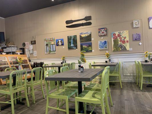 Indoor seating (outdoor seating also available), bakery goods counter and art work available for sale.