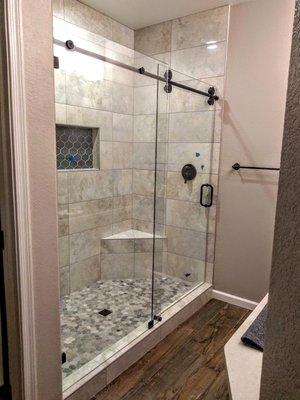 Barn Door style glass shower. Makes a pop in any bathroom