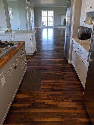 Again existing water damaged floor refinished and blended into new walnut flooring.