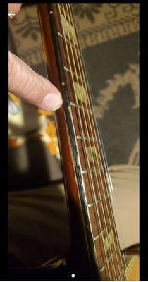 Damaged fretboard covered over with paint or marker. This was not disclosed before purchase.