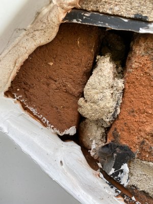 Chimney with visible cracks and missing mortar