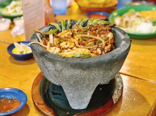 Molcajete - steak, chicken, shrimp, chorizo, onions, peppers, cactus