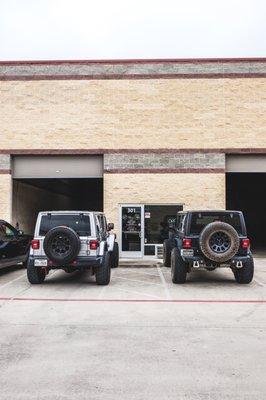 Jeeps out front of office