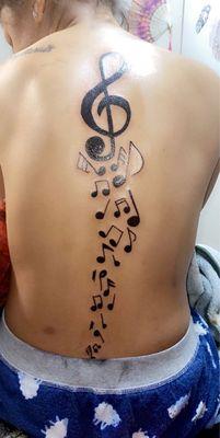 The Love of music. Music notes down the spine in a slight curve.