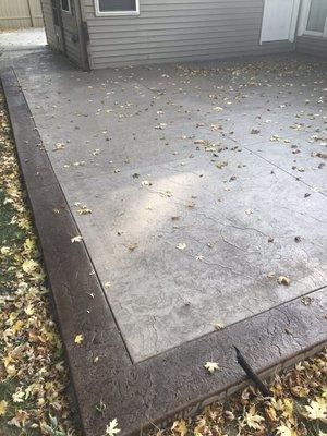 Stamped concrete patio with stamped darkened boarder