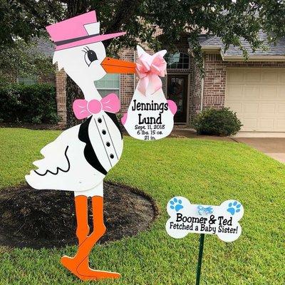 6 foot pink stork and dog bone sign.