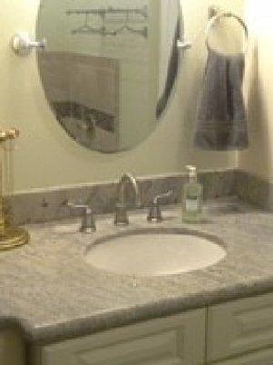 Bathroom cabinets, under mount sink and granite top.