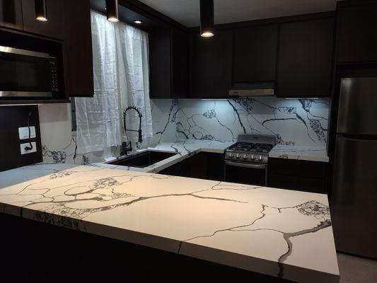 Kitchen countertop renovation with waterfall and full backsplash.