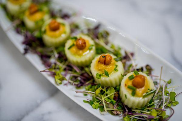 Home made hummus and crispy chic pea in cucumber basket