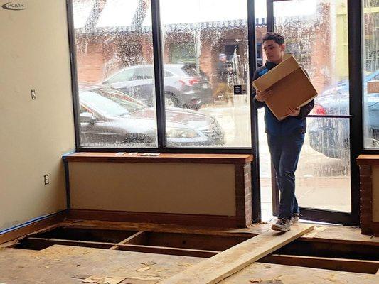 Joshua Cymer helps move a box to the new 209 North Holden Street location.