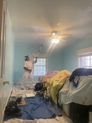 Father of Garcia & Son painting the ceiling a flat white