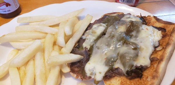 Roast beef and green chili sandwich with fries