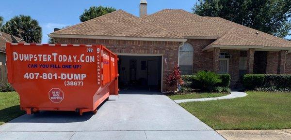 Residential Dumpsters, clean and placed safely on a driveway for easy access.