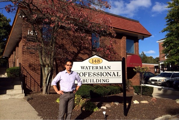 Dr. Lee in front of the office