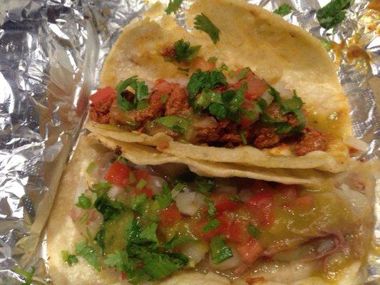 Desebrada con papa (shredded beef with potato) and al pastor (spicy pork) taco.