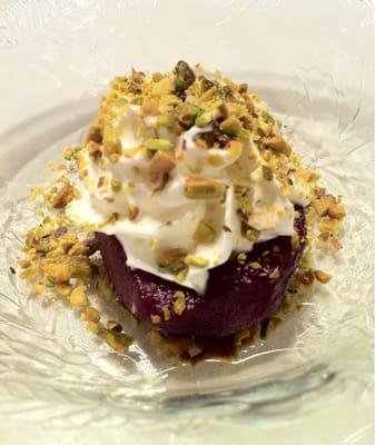 Dessert - red wine poached pear with whipped cream and pistachios