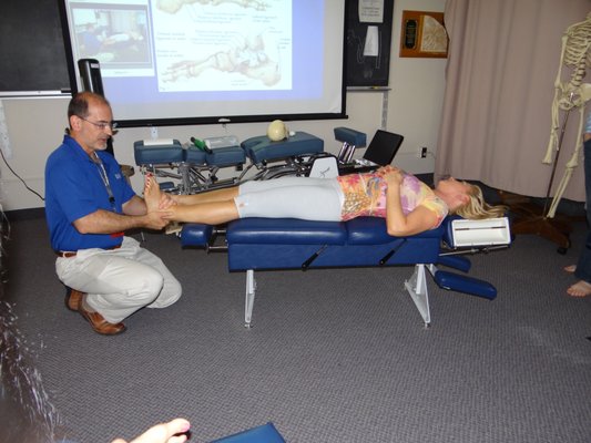 Demonstrating foot and ankle adjustments at a seminar for doctors.