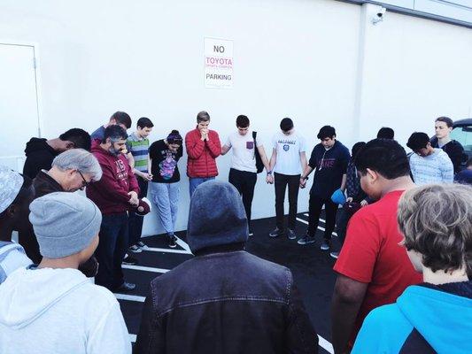 Students and staff praying together as we are commissioned off by Mr. Silva for our yearly missions trip to Mexico!