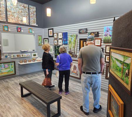 A few customers and artists mingle in the main gallery