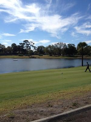 Practice putting green and aqua rang in background