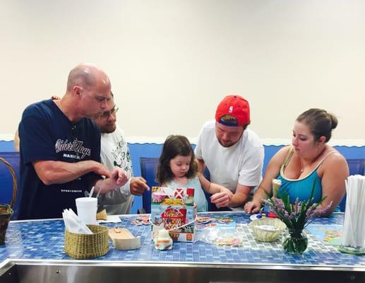 The whole family gathered to help their daughter finish the puzzle! And she did! Team work