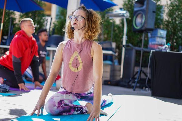 Teaching outdoor group yoga.