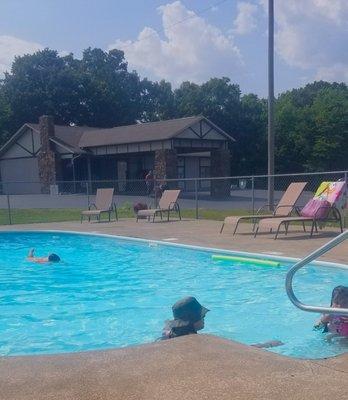 On a warm sunny day a family enjoying our blue, clean, refreshing pool.