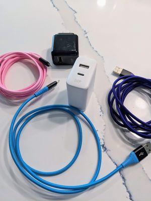 USB-C to Apple iPAD lightning cables in kevlar wrapped blue, pink and purple along with wall chargers.