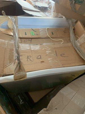 Items marked "fragile, stuffed in a bin with tape because they ran out of packing supplies