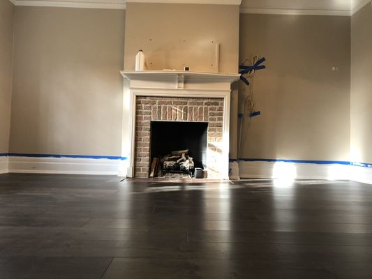 Existing hardwood and subflooring removed, new plywood with leveling installed. And Prefinished engineered wood floor installed on top.