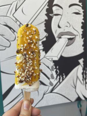 Coconut Pop with passion fruit sauce and almonds