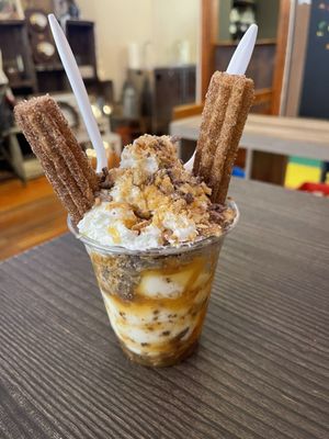 Churro, Vanilla soft serve, caramel drizzle, toffee, and toffee cashews on top!