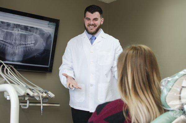 Dr. Noll explaining treatment to a patient.