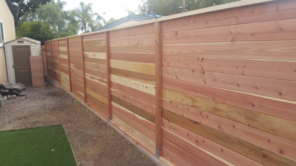 My new retaining wall with horizontal slat fence on top.