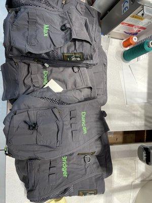 Fishing vests with names embroidered on them.