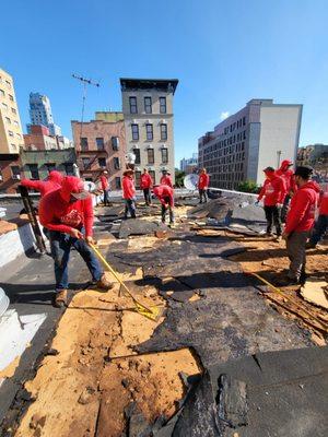 The Royal team removing debris, preparing for a new flat roof - Royal Renovators Inc.